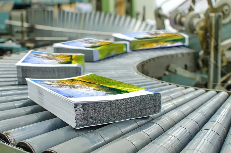 Printed pieces moving through finishing equipment